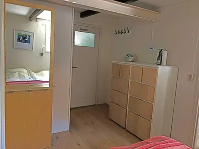 a room with a bedroom with a bed and a door at 