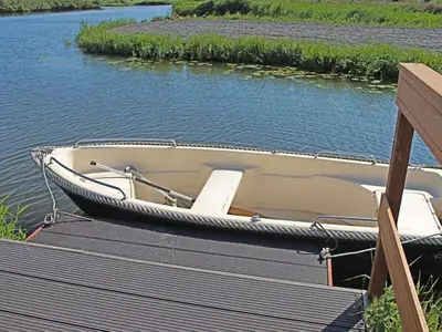 a boat sitting on the water next to a dock at 