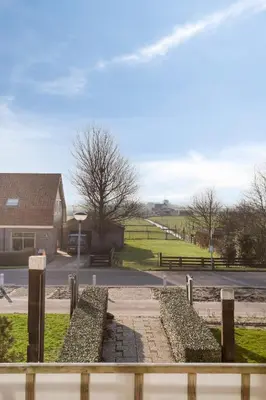 a view from a fence of a park with a street at Comfortable Stay Near The Coast in Burgerbrug