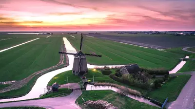 an aerial view of a windmill in a field at Comfortable Stay Near The Coast in Burgerbrug