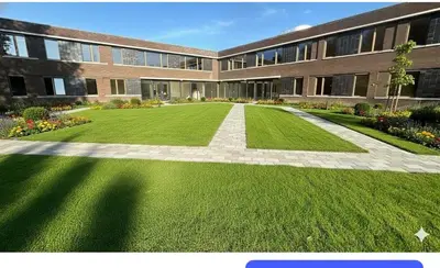 a large building with a green lawn in front of it at Lely in Lelystad