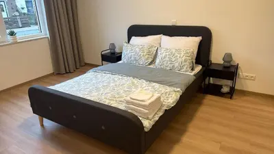 a bedroom with a large bed with pillows on it at Lely in Lelystad