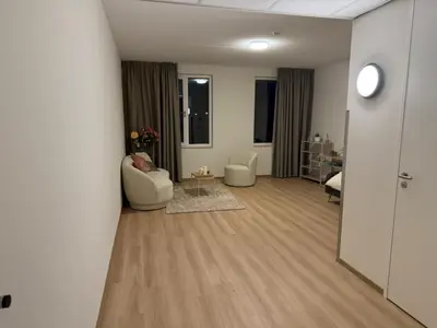 a living room with two chairs and a table at Lely in Lelystad