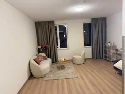 a living room with two chairs and a table at Lely in Lelystad