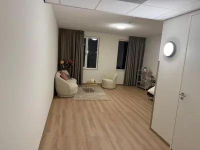 a living room with two chairs and a table at Lely in Lelystad