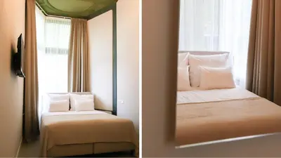 a mirror in a room with a bed and a window at Dam Residence - Boutique Hotel in Zaandam