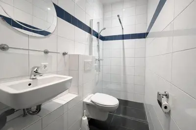 a white bathroom with a sink and a toilet at De Beemster | Group accommodation near Amsterdam in West-Graftdijk