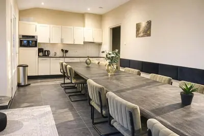 a large dining room with a long table and chairs at De Beemster | Group accommodation near Amsterdam in West-Graftdijk