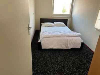 a bedroom with a bed and a window at Fokkeboom in Almere