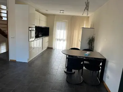 a kitchen with a table and chairs in a room at Fokkeboom in Almere