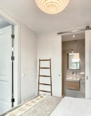 a bedroom with a ladder next to a bed at Top Floor Apartment Vondelpark in Amsterdam