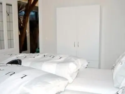a row of white pillows sitting on a bed at Holiday Home Markermeerlogies by Interhome in Bovenkarspel
