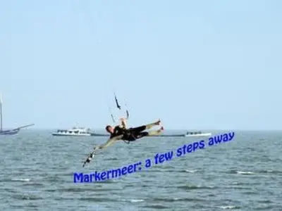 a man in the air doing a trick in the water at Holiday Home Markermeerlogies by Interhome in Bovenkarspel