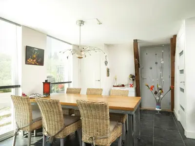 a dining room with a wooden table and chairs at Holiday Home Markermeerlogies by Interhome in Bovenkarspel