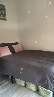 a large bed with two pillows on it in a room at Studio Mokum in Amsterdam