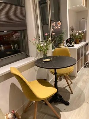 a table and chairs in a room with a window at Studio Mokum in Amsterdam