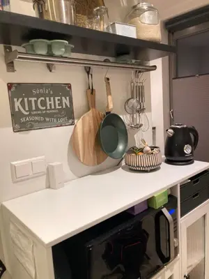 a kitchen counter with utensils and a sign on the wall at Studio Mokum in Amsterdam