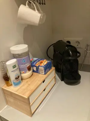 a wooden shelf with food and a bag on a counter at Studio Mokum in Amsterdam