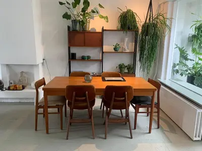 a dining room with a wooden table and chairs at Botanico - family house in Egmond aan Zee