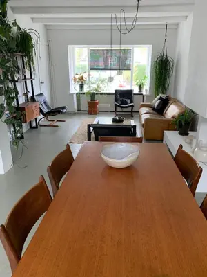 a living room with a wooden table and a couch at Botanico - family house in Egmond aan Zee