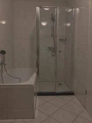 a bathroom with a shower and a tub and a sink at Casa Amare in Egmond aan Zee