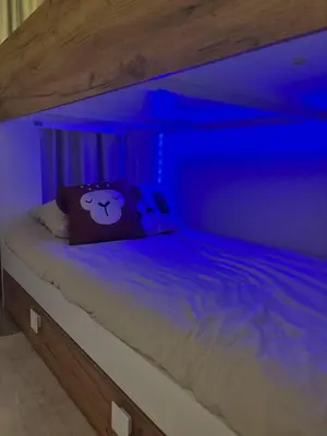 a bed with a blue light on it at Casa Amare in Egmond aan Zee