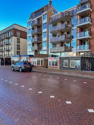 a car parked in a parking lot next to a building at Casa Amare in Egmond aan Zee