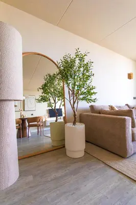 a living room with a couch and a table at Casa Amare in Egmond aan Zee