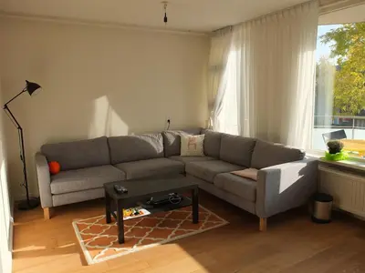 a living room with a couch and a table at Cozy 2 Bedroom Home Away from Home in Amsterdam