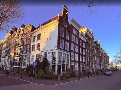 a large building on the side of a street at Houseboat Avontuur in Amsterdam