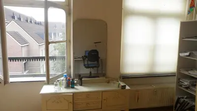 a bathroom with a sink and a large window at Studio in Ons Belang