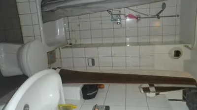 a small bathroom with a toilet and a sink at Studio in Ons Belang