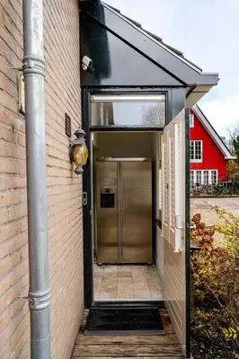 an entrance to a building with a metal door at Charming Loft with Free Parking and 15 mins to AMS in Vinkeveen