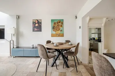 a kitchen and dining room with a table and chairs at Charming Loft with Free Parking and 15 mins to AMS in Vinkeveen