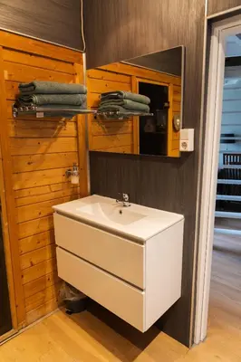 a bathroom with a white sink and a mirror at De Stranding Nieuw in Egmond aan den Hoef