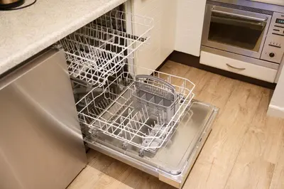 a dishwasher with a dish rack in a kitchen at Lighthouse Beach Apartment in Noordwijk aan Zee