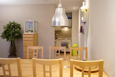 a kitchen and dining room with a table and chairs at Lighthouse Beach Apartment in Noordwijk aan Zee