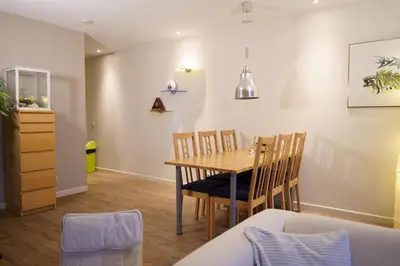 a dining room with a table and chairs at Lighthouse Beach Apartment in Noordwijk aan Zee