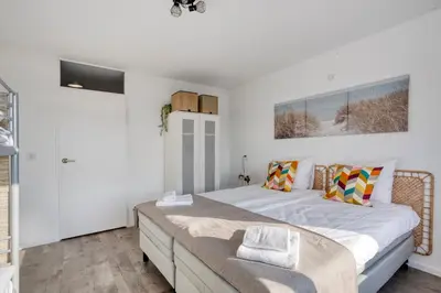 a bedroom with a large bed and a window at Comfortable Stay Close To The Coast in Burgerbrug