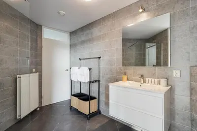 a bathroom with a sink and a mirror at Comfortable Stay Close To The Coast in Burgerbrug