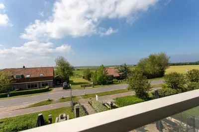 a view from a balcony of a street with a building at Comfortable Stay Close To The Coast in Burgerbrug