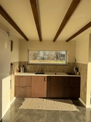 a kitchen with a sink and a window at Studio34 in Hauwert