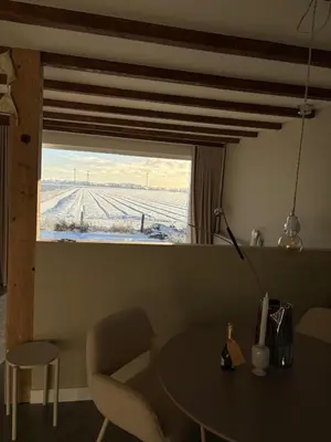 a table and chair in a room with a window at Studio34 in Hauwert