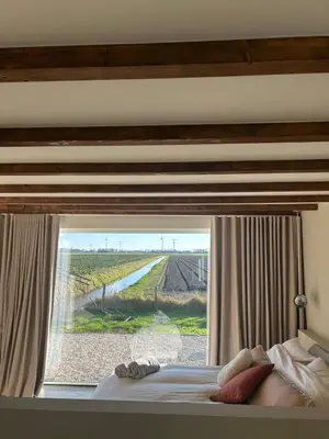 a bedroom with a window with a view of a field at Studio34 in Hauwert