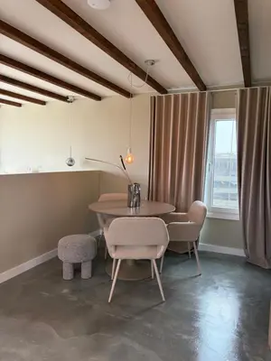a dining room with a table and chairs and a window at Studio34 in Hauwert