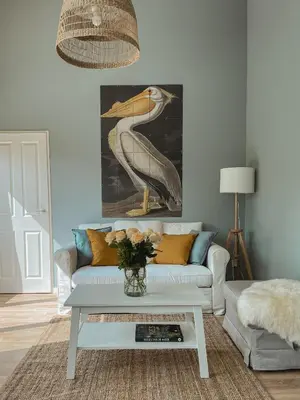 a living room with a white couch and a table at The Pelican in Warmenhuizen