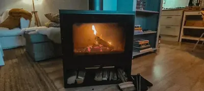a fireplace in the middle of a living room at The Pelican in Warmenhuizen