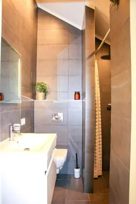 a bathroom with a toilet and a sink at Strandbries in Warmenhuizen
