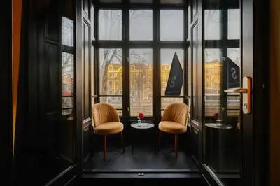 two chairs and a table in front of a window at Supper Boutique Suites in Amsterdam
