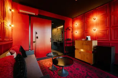 a red living room with a couch and a table at Supper Boutique Suites in Amsterdam